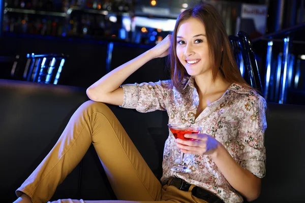 Attractive woman in night club with a drink Royalty Free Stock Photos