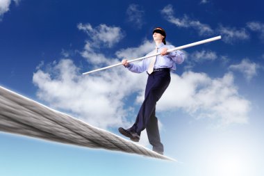 Business man balancing on the rope clipart