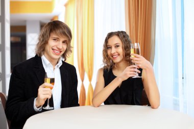 Couple in a restaurant with shampagne clipart