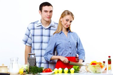 Husband and wife together coooking at home clipart