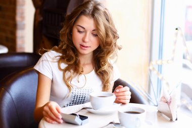 Young couple with engagement ring in a restaurant clipart