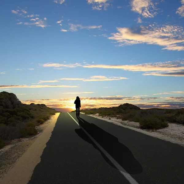 Homme s'éloignant à l'aube le long de la route — Photo