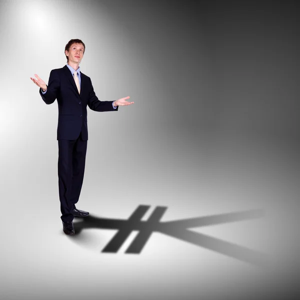 Uomo d'affari con ombra come simbolo di valuta — Foto Stock