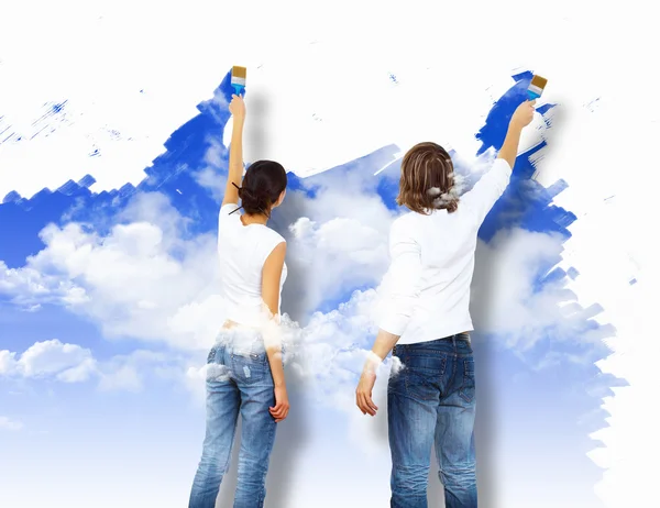 stock image Young couple with paint brushes together