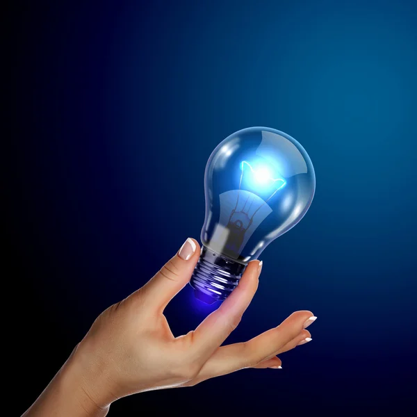 Mänsklig hand innehav elektrisk lampa — Stockfoto