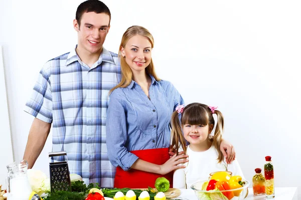 Family with a daughter cooking together at home — Stock Photo, Image