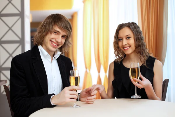 Couple in a restaurant with shampagne — Stock Photo, Image