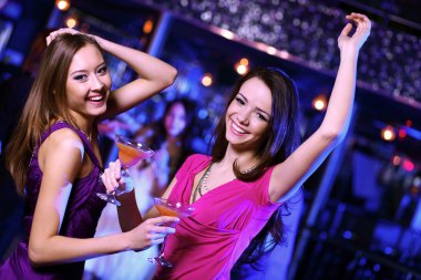 Young woman having fun at nightclub disco clipart