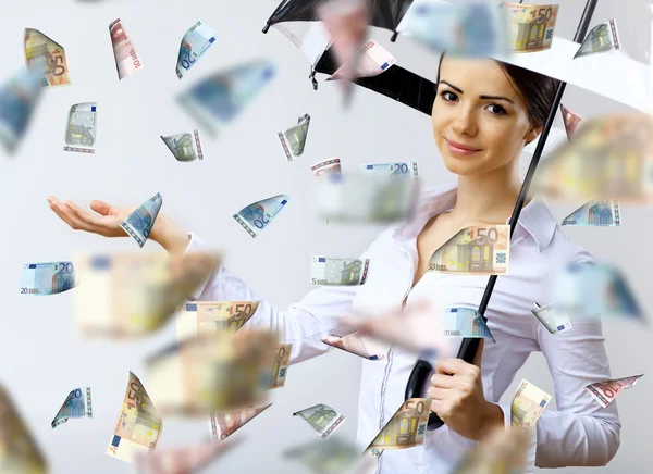 Business woman under money rain with umbrella — Stock Photo, Image