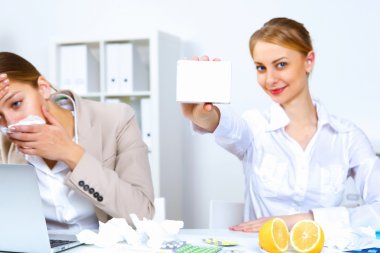 Woman in office holding a pack of medicine clipart