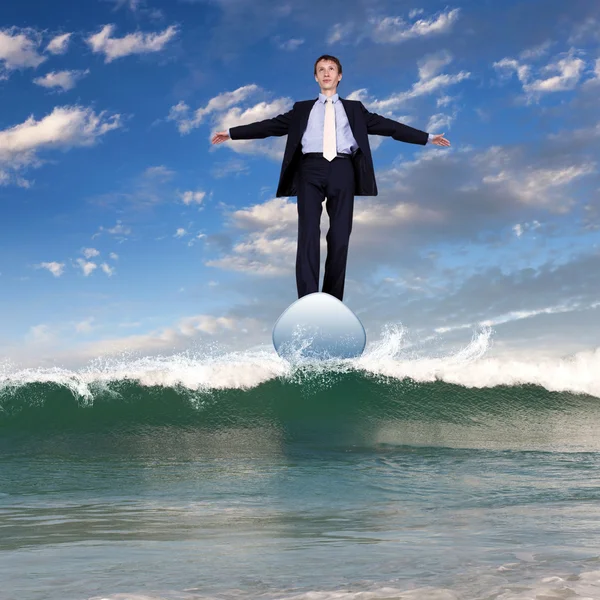 Businessman surfing on the sea waves — Stock Photo, Image
