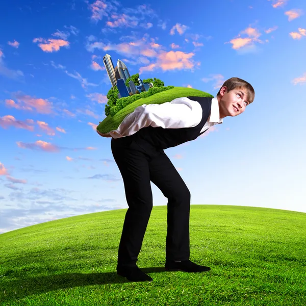 Young businessman carrying world — Stock Photo, Image