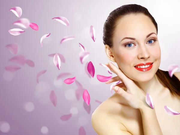 Young woman with flowers on background — Stock Photo, Image