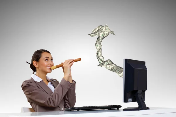Businesswoman at workplace and money symbols — Stock Photo, Image