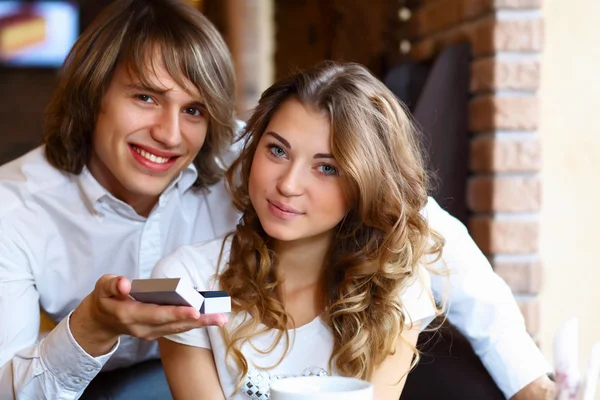 Young couple with engagement ring in a restaurant — Stock Photo, Image