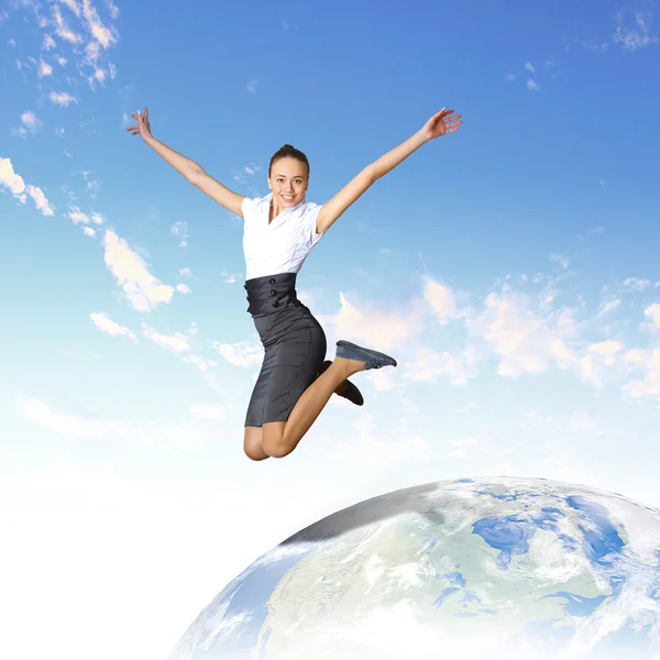 stock image Young woman jumping and our planet earth