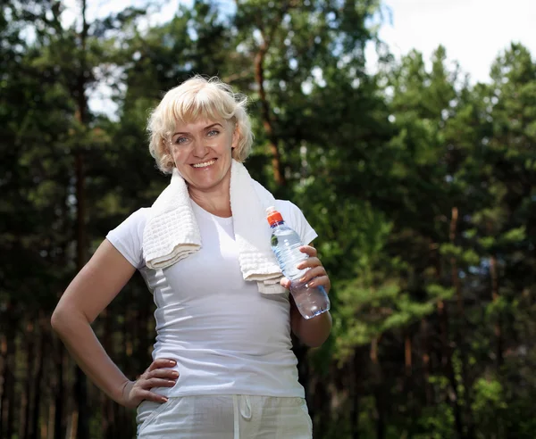 Elderly woman after exercising in the forest — Stock Image Elderly woman after exercising in the forest Stock Image