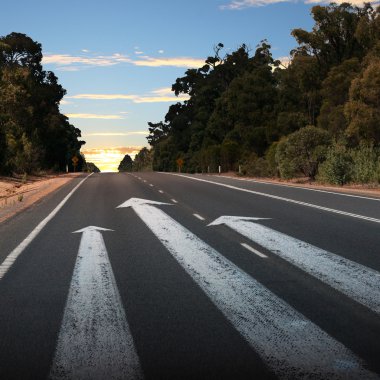 Empty countryside road with white arrow clipart