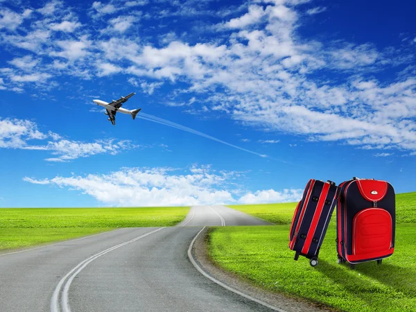 Červený kufr a letadlo — Stock fotografie
