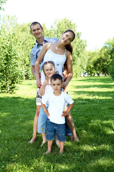 Family with two children in the summer park — Stok fotoğraf