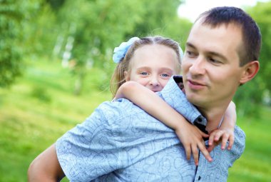 Father and daughter in the summer park