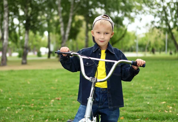 Ragazzo in bicicletta nel parco verde — Foto Stock
