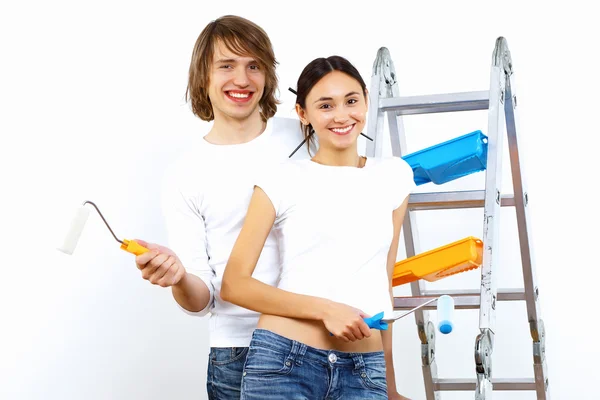 Young couple with paint brushes together — Stock Photo, Image