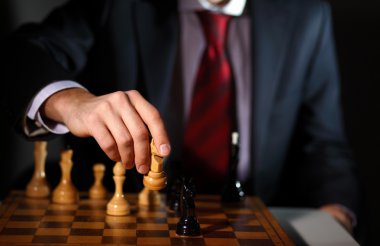 Businessman playing chess clipart