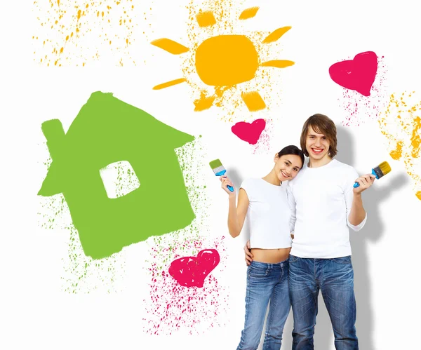 Young couple with paint brushes together — Stock Photo, Image