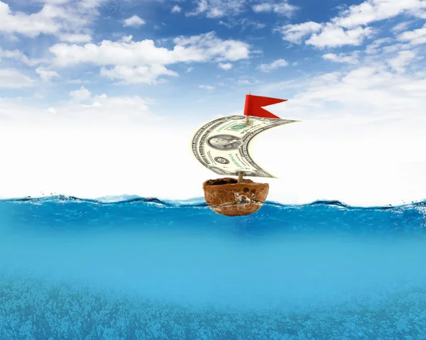 Nutshell ship with dollar banknote sail — Stock Photo, Image
