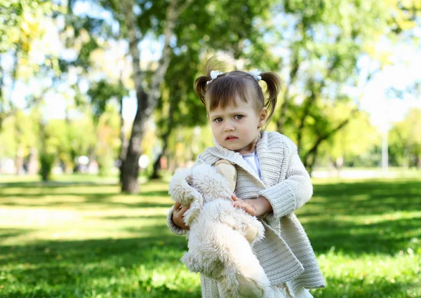 Little girl playing in green summer park — Stock Photo, Image