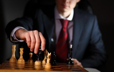 Businessman playing chess clipart