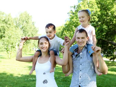 Family with two children in the summer park