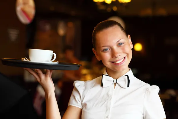 Portrait of young waitress holding a tray — Stock Photo, Image