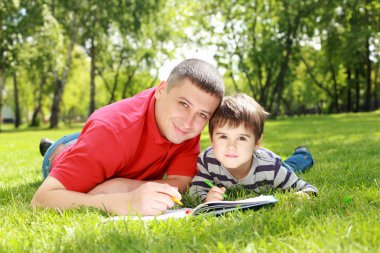 Father with his son in the park clipart