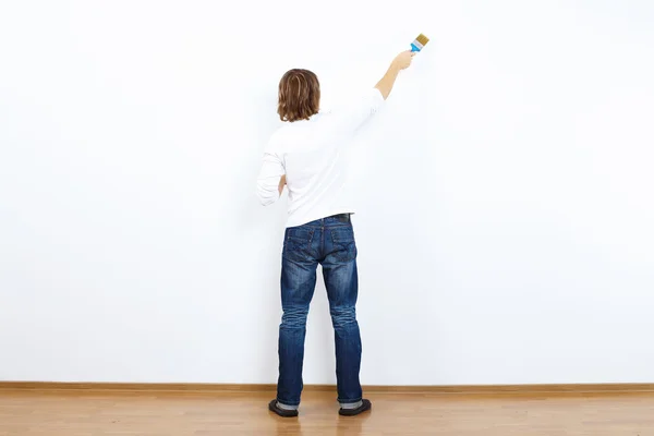 Young man with paint brush — Stock Photo, Image