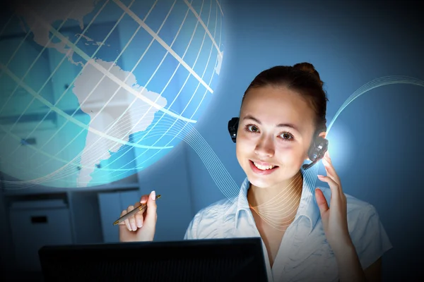 Young woman in business wear and headset — Stock Photo, Image