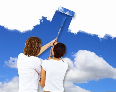 Young couple with paint brushes together clipart