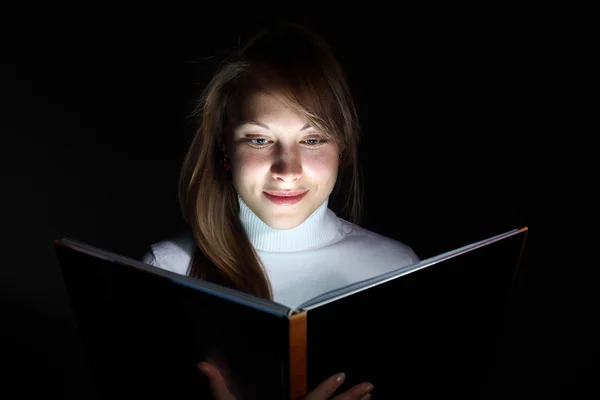 年轻女子读一本神奇的书 — 图库照片