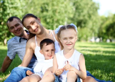 Family with two children in the summer park