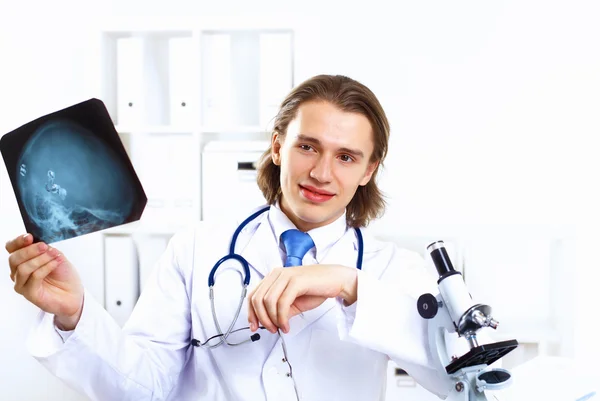Friendly doctor in medical office — Stock Photo, Image
