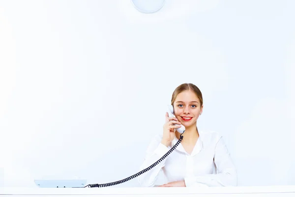 Jeune femme avec un téléphone au bureau — Photo