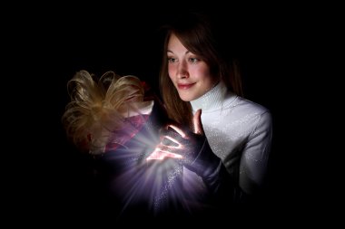 Young woman reading a magic book