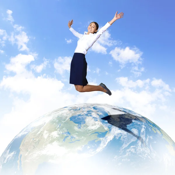 stock image Young woman jumping and our planet earth