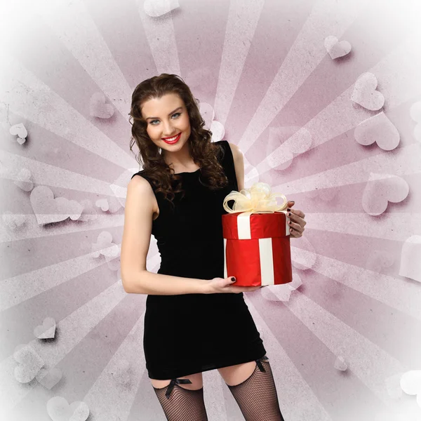 Woman in black dress with a gift box — Stock Photo, Image