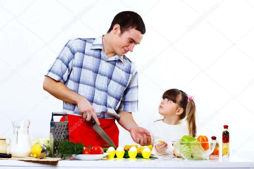 Family with a daughter cooking together at home