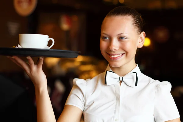 stock image Portrait of young waitress holding a tray