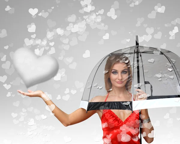 Pretty young woman with umbrella and hearts — Stock Photo, Image