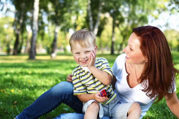 Young mother with her son in summer park Stock Image