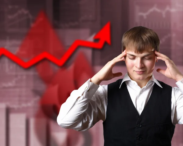 Young businessman against financial graphs — Stock Photo, Image